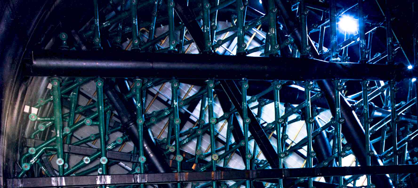 An array of spiral nozzles layered inside of an open-tower wet flue gas desulfurization structure.