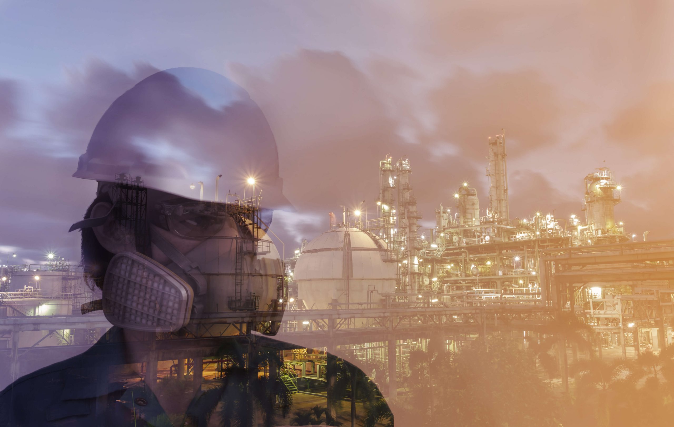 Image of chemical engineer in front of a chemical refinery plant